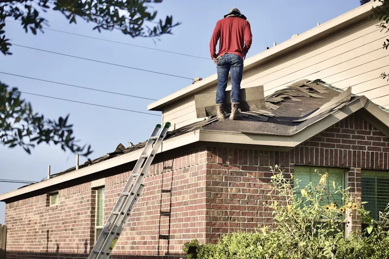 Professional roofer working on a residential roof in Aurora Knolls at Hutchinson Heights